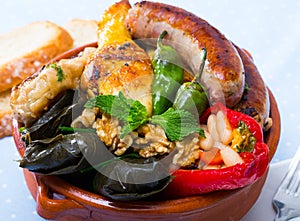 Tasty bulgarian kapama with grape rolls, sausage, chicken and stuffed pepper
