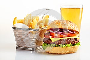 Tasty burger with basket of fries and beer