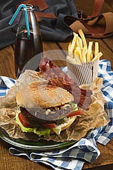 Tasty burger with beef and french fries and soda