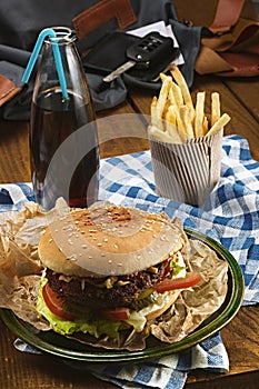 Tasty burger with beef and french fries and soda