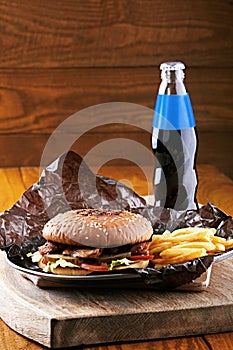 Tasty burger with fries and sauce