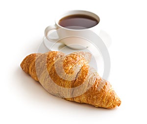 Tasty buttery croissant and cup of coffee.