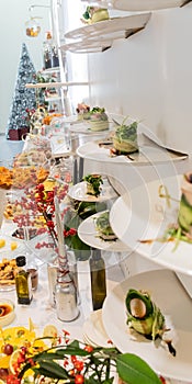 Tasty canapes plates in line hanging with caviar