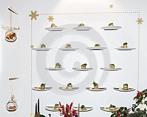 Tasty canapes plates in line hanging with caviar and cream
