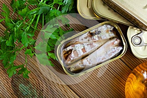 Tasty canned mackerel fish in sunflower oil with greens