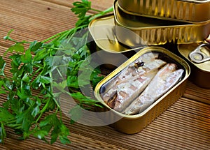 Tasty canned mackerel fish in sunflower oil with greens