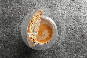 Tasty cantucci and cup of aromatic coffee on grey table, top view. Traditional Italian almond biscuits