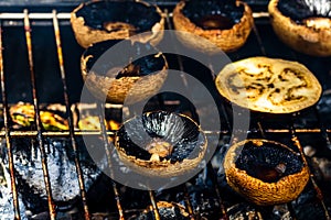 Tasty champignon  mushrooms and veggies being cooked on charcoal grill