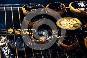 Tasty champignon  mushrooms and veggies being cooked on charcoal grill