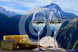 Tasty cheese and wine from Savoy region in France, beaufort, abondance, emmental, tomme and reblochon de savoie cheeses and glass