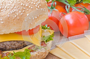 Tasty cheeseburger with lettuce, beef, double cheese and ketchup.