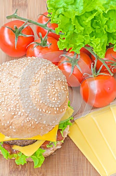 Tasty cheeseburger with lettuce, beef, double cheese and ketchup.