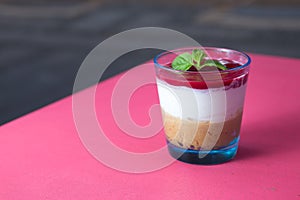 Tasty cheesecake in a glass cup