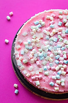 Tasty Cheesecake with Marshmallows for Birthday Party on Pink Background