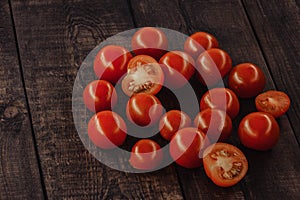 tasty cherry tomatoes on a wooden stand, wooden background