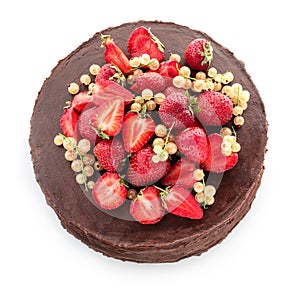 Tasty chocolate cake with strawberries and currants on white background