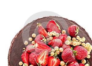 Tasty chocolate cake with strawberries and currants on white background