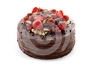 Tasty chocolate cake with strawberries and currants on white background