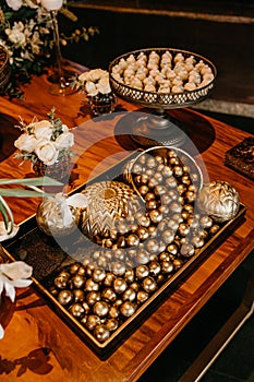 Chocolate Cherry cookies and  bouquets on wooden table at a edding party, vertical shot photo