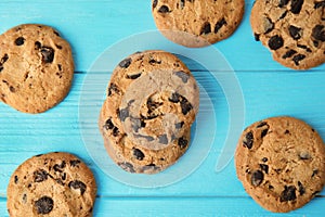 Tasty chocolate chip cookies on wooden background