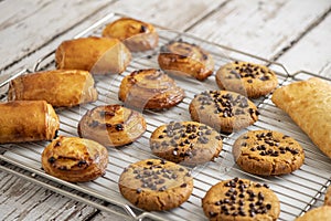 Tasty chocolate cookies, croissant, ciabatta bread