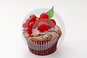 Tasty chocolate cupcake with berries, isolated on white