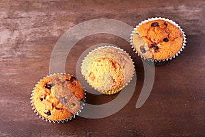 Tasty chocolate cupcakes, muffins on a white wooden table