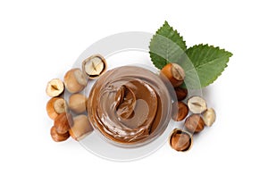 Tasty chocolate hazelnut spread and nuts on white background, top view photo