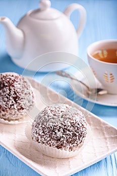 Tasty cocoa and chocolate cakes and cup of tea.