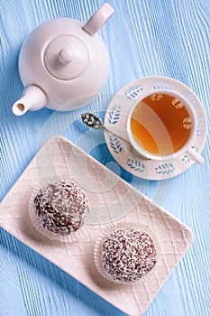 Tasty cocoa and chocolate cakes and cup of tea.