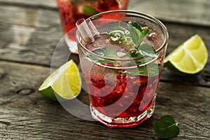 Tasty cold fresh drink lemonade with raspberry, mint, ice and li