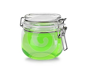 Tasty colorful jelly in glass jar on white
