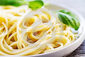 Tasty cooked colorful spaghetti pasta with fresh basil on plate