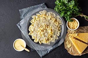 Tasty cooked italian farfalle pasta bow-tie or butterfly with cheese sauce.