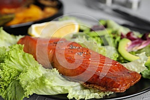 Tasty cooked salmon and fresh salad on plate, closeup. Healthy meals from air fryer