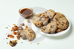 Tasty cookies with caramel on white background