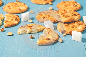 Tasty cookies with nuts and lump sugar on a blue wooden table/tasty cookies with nuts and lump sugar on a blue wooden table,