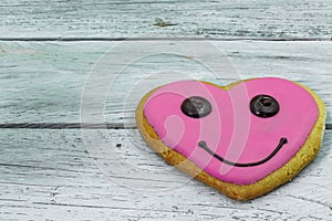 Tasty cookies in the shape of a heart on wooden background