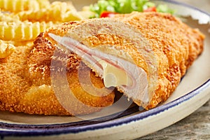 Tasty cordon bleu with cheese on plate photo