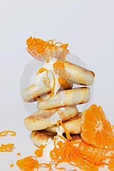 Tasty cottage cheese pancakes with citrus, orange and lemon, isolated on pure white background.