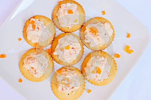 Tasty crackers with cream cheese,carrot.Healthy snacks, on dish