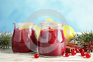 Tasty cranberry sauce with citrus zest in glass jars