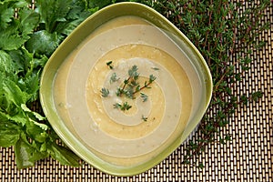 Tasty cream of celeriac soup in a green bowl photo