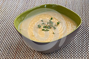 Tasty cream of celeriac soup in a green bowl photo