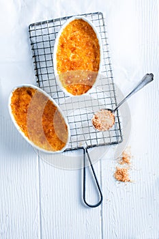 Tasty Crema Catalana on White Wooden Table photo