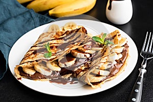 Tasty crepe with hazelnut chocolate spread and banana photo