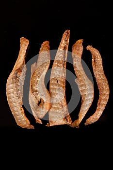 Tasty, crispy, chicken, smoked, crisp snack on a black background