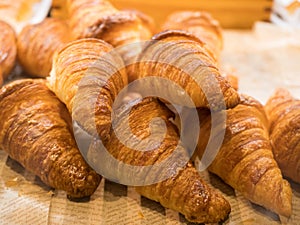 Tasty croissants on the tray sellin in the bakery shop