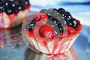 Tasty cup cake with berries on metal tray