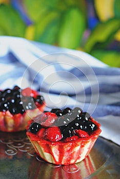 Tasty cup cake with berries on metal tray